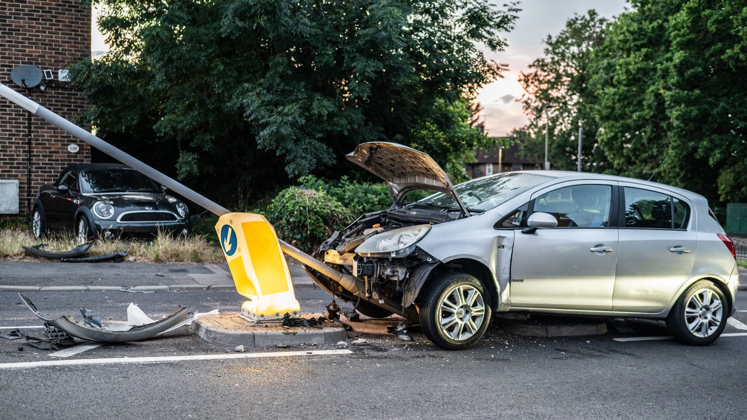 Canadian driver reviewing paperwork after a total loss claim, or a damaged vehicle in an assessment lot